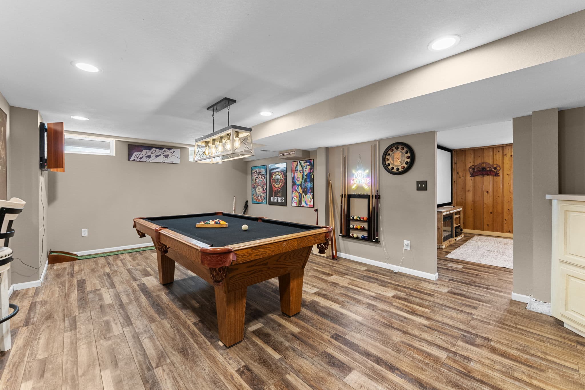 Basement game room with a pool table and movie theater