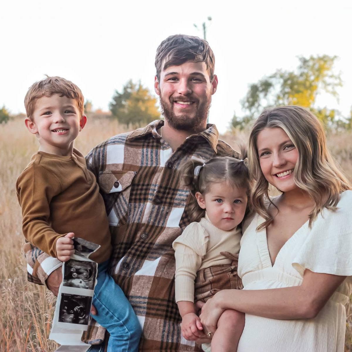 Cameron and Payton with their two kids in a Sioux Falls field